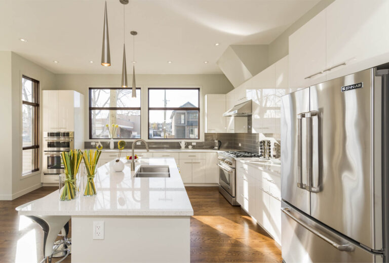 The kitchen features a sleek, white countertop that looks spotless and organized. The counters are free from clutter, and the white surface shines under the light, highlighting the modern and minimalist design. There may be a few subtle items, like a small plant or a decorative bowl, adding a touch of warmth. The kitchen has a bright and open feel, with cabinetry and appliances blending seamlessly into the overall clean and elegant aesthetic. Cleaning Services in Queens