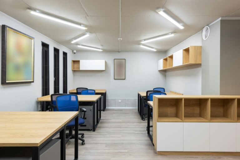 Office with blue chairs and wooden desks. Commercial Cleaning in Moose Jaw